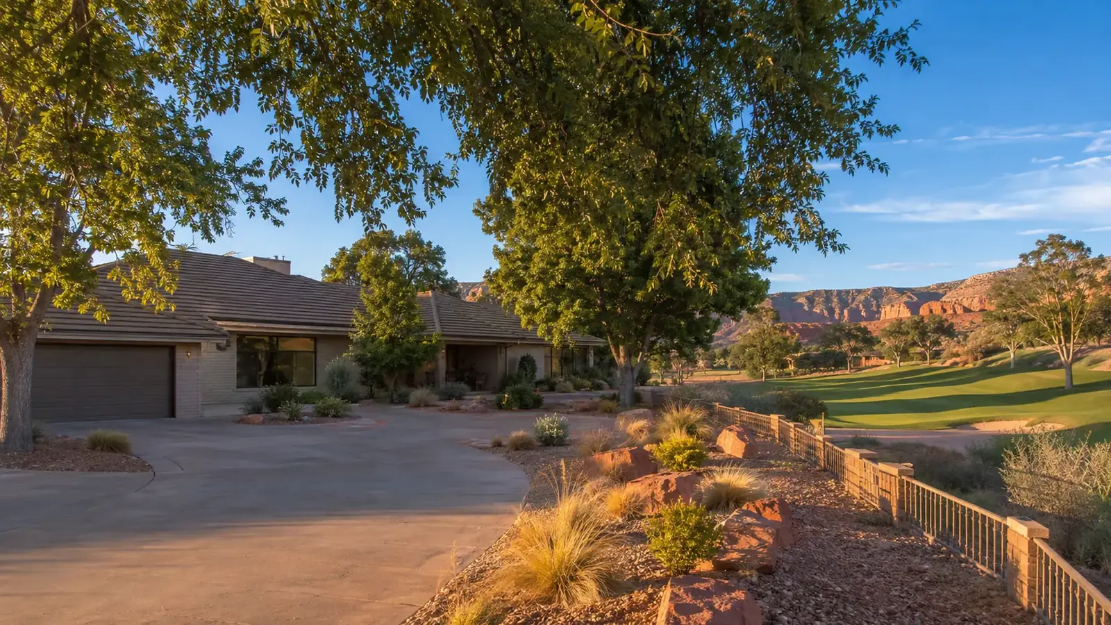Ranch style home in Bloomington Hills, St. George, Utah, with mature trees and a neighboring golf fairway